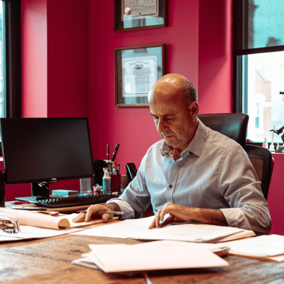 Man reviewing paperwork at office desk