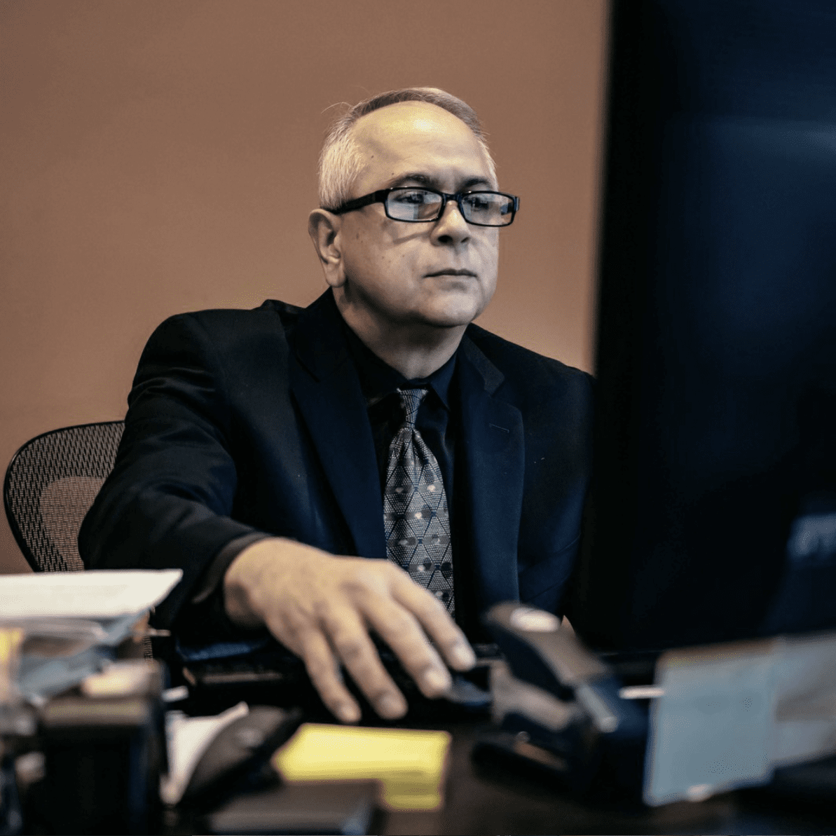 Man in suit working at computer